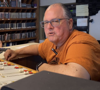 Wade at the controls, in the radio station